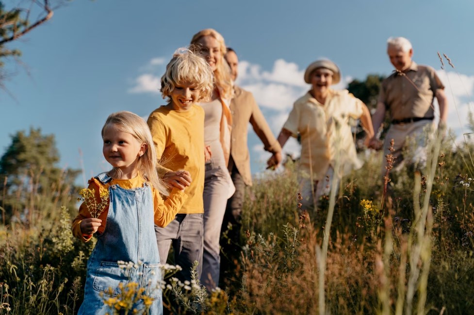 a happy family walking together holding hands in nature