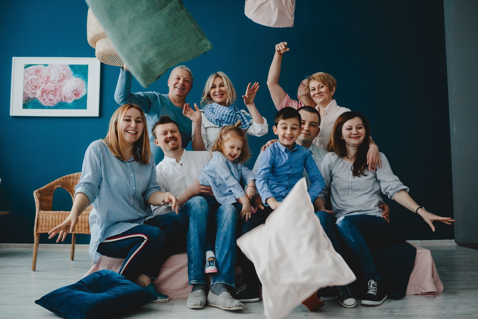 Parents and their little children sit together on the bed