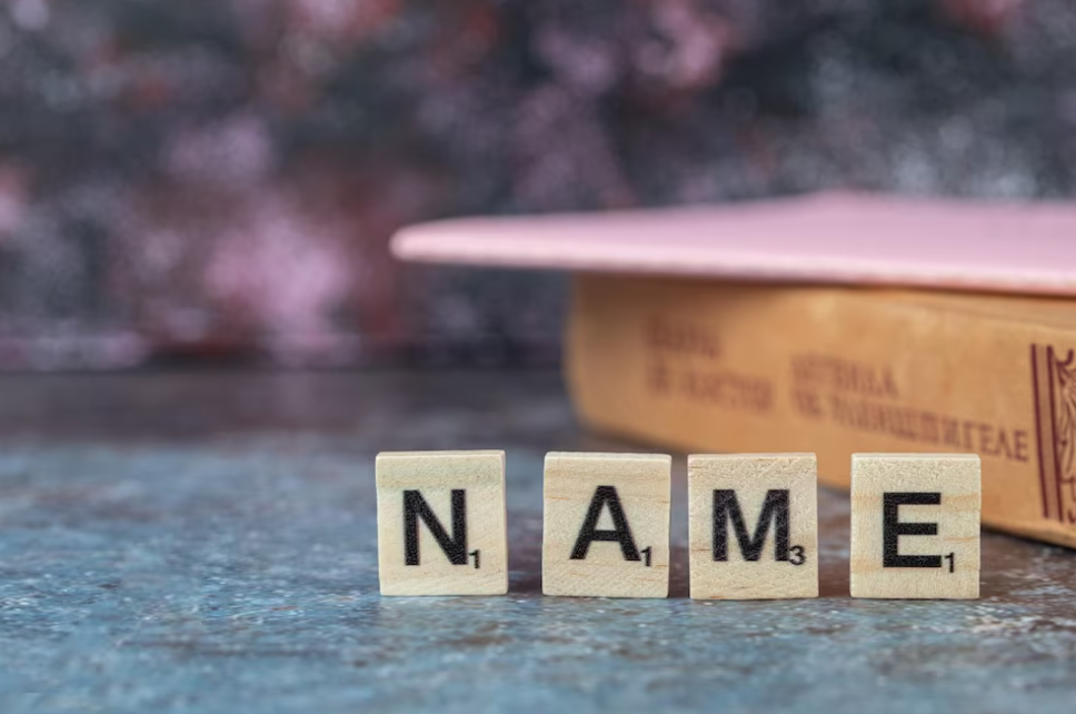 black letters on wooden dices and old book around it on the table