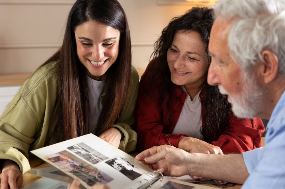 woman and grandparents sitting and watching on the album with photos