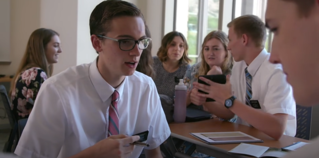 People in formal clothes talking inside a room
